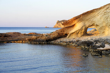 vacations concept. natural cave formed in the rock in a cove of javea in the mediterranean.