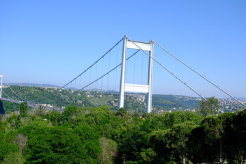 Fatih Sultan Mehmet Bridge, the second bridge across the Bosphorus. Bridge pier. Traffic flow on the bridge. Fatih Sultan Mehmet Bridge with trees. Tourism destination. Istanbul - Turkey.