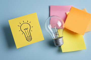 Light Bulb With Sticky Notes on Yellow Background
