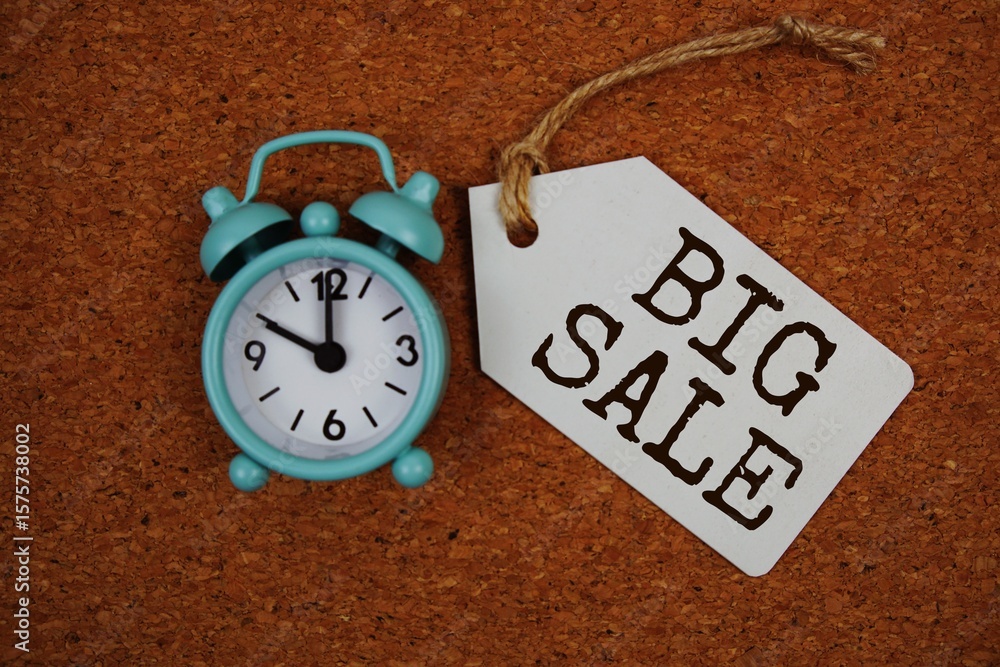 Poster big sale text on price tag with alarm clock on cork board background