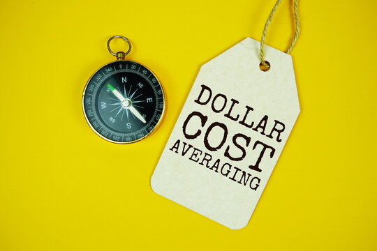 Dollar-cost Averaging text on price tag with compass on yellow background