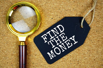 Find The Money text on price tag with magnifying glass on cork board background