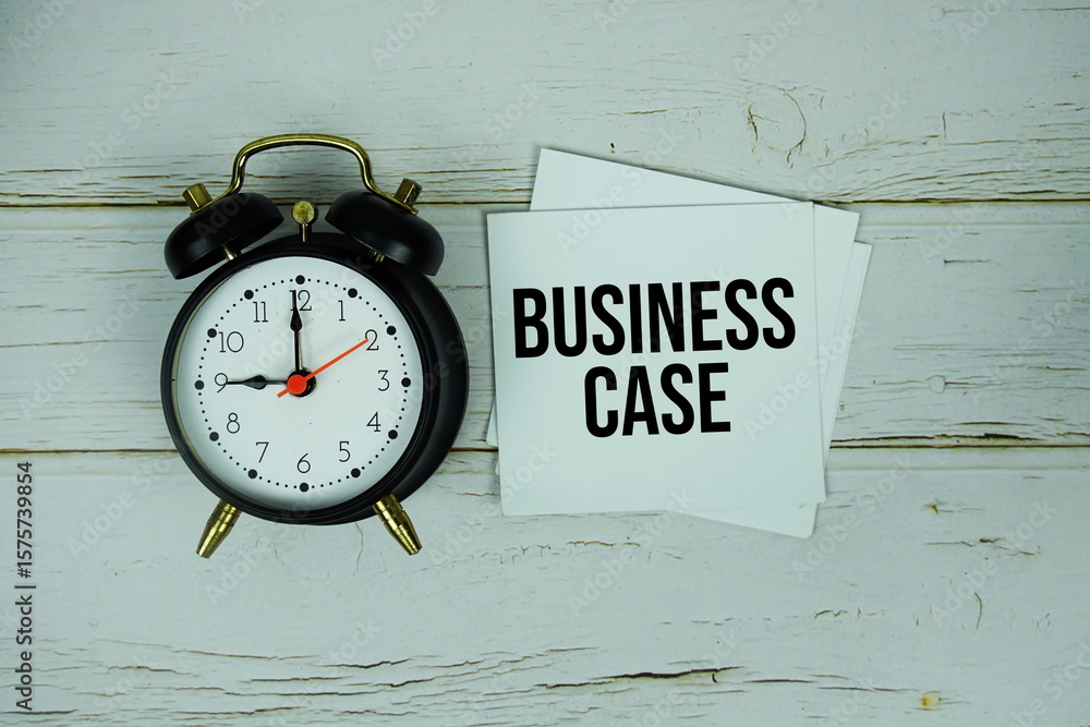 Poster business case text message on paper with alarm clock on wooden background