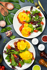 Set of sandwiches and bruschetta with fish, bacon, avocado and egg. Top view, on a dark stone background.