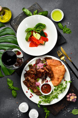 Food background. Fresh kebab, fresh vegetables and Georgian bread in a plate. Top view.