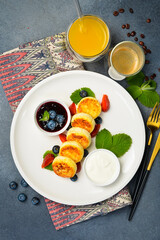 Breakfast. Cottage cheese pancakes with berries, jam and sour cream. Healthy meal.