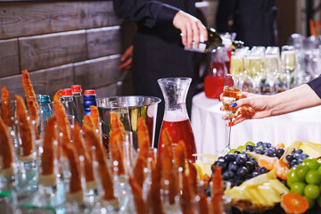 battered shrimps against the background of a waiter with champagne