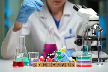 A skilled chemist expertly conducts complex experiments focusing on synthesis within a controlled...