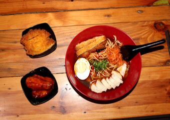 Indulge in rich Japanese ramen, uniquely paired with crispy Indonesian yam katsu. A fusion delight