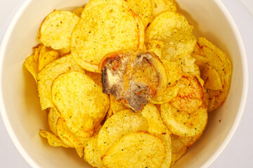 rotten potato chips. potato chips with spices in a bowl.