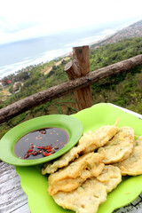 Crispy Tempe Mendoan with a stunning ocean view. Taste Indonesian flavors by the sea. Perfect for...