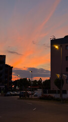 Urban view of Lloret de Mar at sunset with warm sky tones and silhouettes of buildings. Captures the peaceful atmosphere of a summer evening in a Mediterranean town.