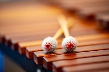 Xylophone with two mallets lying crossed on the wooden tone bars. Close-up of the classical musical...