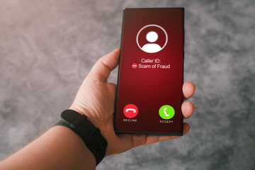 Woman holding phone while receiving unwanted call. Spam, scam, phishing and fraud concept. Security...