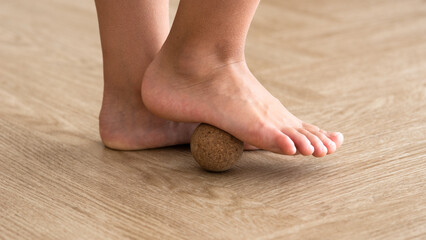 prevention of flat feet concept, closeup of child's feet with massage ball, orthopedic, exercises