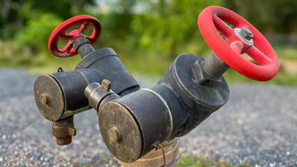 A close-up of a fire hydrant with two red valves. Used in fire extinguishing and water supply...