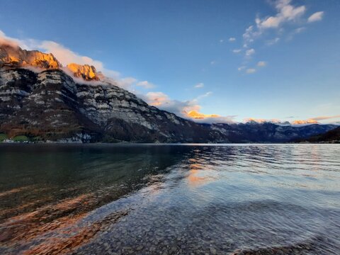 sunset over lakeside mountains