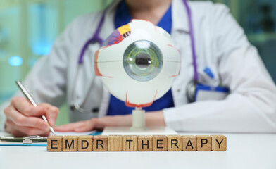 A healthcare professional is conducting EMDR therapy using a unique eye apparatus designed for...