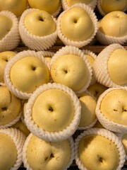 Pears are arranged for sale in the department store. 