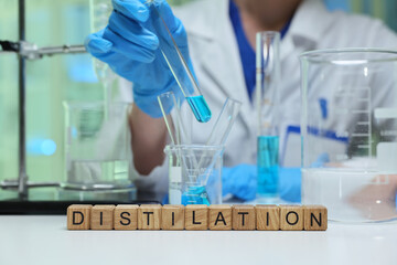 A highly skilled scientist expertly distills vibrant blue liquids in a wellequipped laboratory...