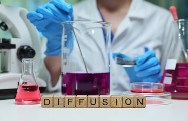 A scientist demonstrates the fascinating process of diffusion in a lab filled with vibrant...