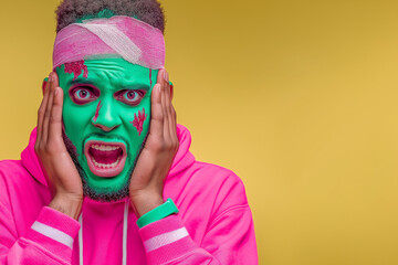 A stylish man with painted face, dressed in green, pink, and yellow tones, striking a bold pose — a vibrant and playful take on the classic Halloween theme.