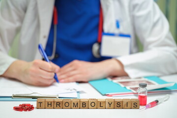 A healthcare professional performs thrombosis treatment, highlighting medical tools and focus on patient care.