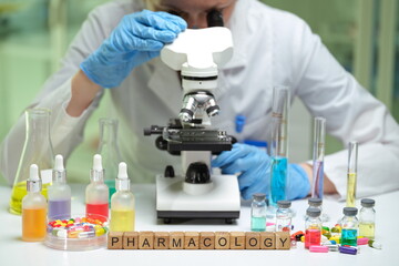 Engaging in an exciting exploration of pharmacology using a microscope and vibrant, colorful...