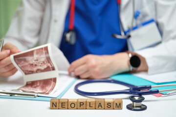 A trained healthcare professional meticulously analyzes medical imaging associated with neoplasm...