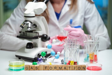 A skilled scientist conducts an innovative gas formation experiment with a microscope and colorful solutions