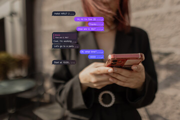 Close-up of young woman with smartphone, city background blurred. Focus on hands. Attractive woman in blazer reading message on phone. Writes Messages in Messenger