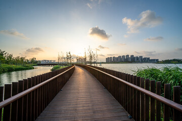 round walkway over lake with sunset