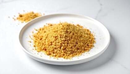 Pile of finely ground, light golden crumbs on a white plate