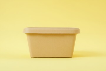 Eco-friendly Reused Food Container on a Bright Yellow Background