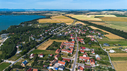 Reservoir with a dam against the backdrop of the Krkanosz Mountains. Poland, Mietkow, Bozhigniew. Drone view.