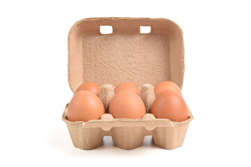 Open egg box with brown eggs isolated on white background with clipping path. Fresh organic chicken eggs in carton pack or egg container