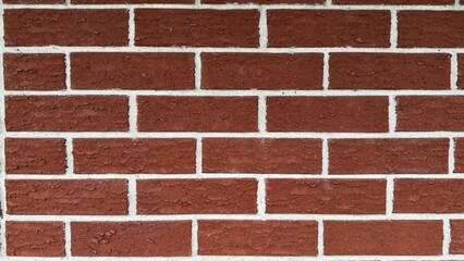 Textured red brick wall with pronounced white mortar — classic architectural background for construction, urban design, and interior visualizations