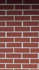 Textured red brick wall with pronounced white mortar — classic architectural background for...