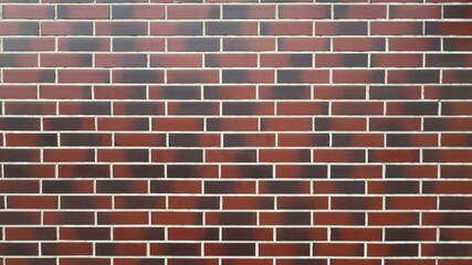 Red brick wall with white mortar lines and black spots — classic texture for architectural,...