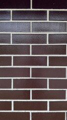 Modern brown brick wall texture on building exterior, ideal for architectural and design projects