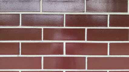 Decorative brown brick wall with glossy finish and light joints &mdash; modern texture for architectural projects, facade design, and graphic applications