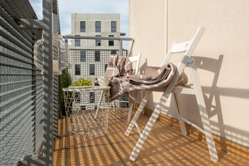 Modern Balcony Lounge With Chairs, Table, and Relaxing Niches in Urban Setting
