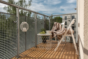 Modern Balcony Lounge With Chairs, Table, and Relaxing Niches in Urban Setting