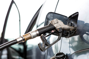 Gas station. Refueling a car with gasoline. Fuel dispenser in the car's fuel tank at a gas station....