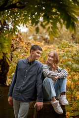 Young Cute Female Hugs Boyfriend. In Autumn Outdoor. Lovers Walking in Park. Attractive Funny Couple. Lovestory in Forest. Man and Woman. Cute Lovers in the Park. Family Concept. Happy Couple.