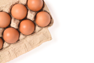 Eggs in paper tray isolated on white background. Top view