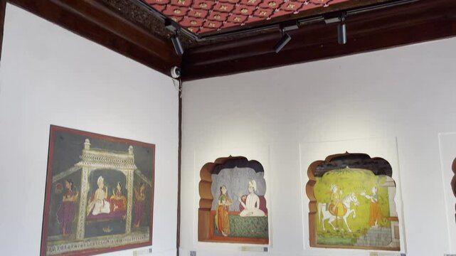 A tilt-up view reveals a Maratha history painting hanging on the wall in one of the rooms at Nana Fadnavis Wada, Wai, Maharashtra. highlighting its rich colors and heritage 4K