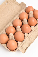 Egg carton with eggs isolated on white background Fresh organic eggs in a cardboard box
