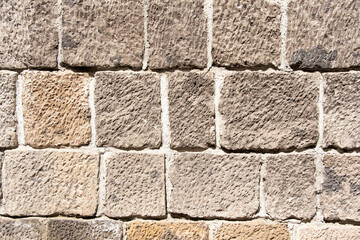 The wall of a house in Armenia is made of black tuff blocks