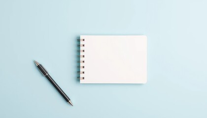 Blank notepad and pen on a blue background